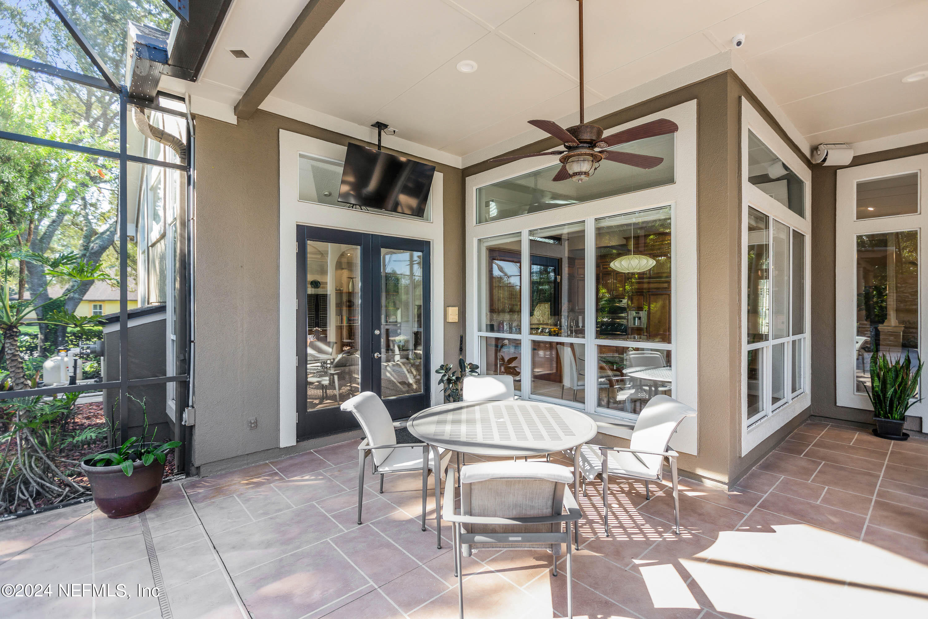 9975 Vineyard Lake Road East Jacksonville, FL 32256 - Photo 27 of 57 a patio with yard table and chairs