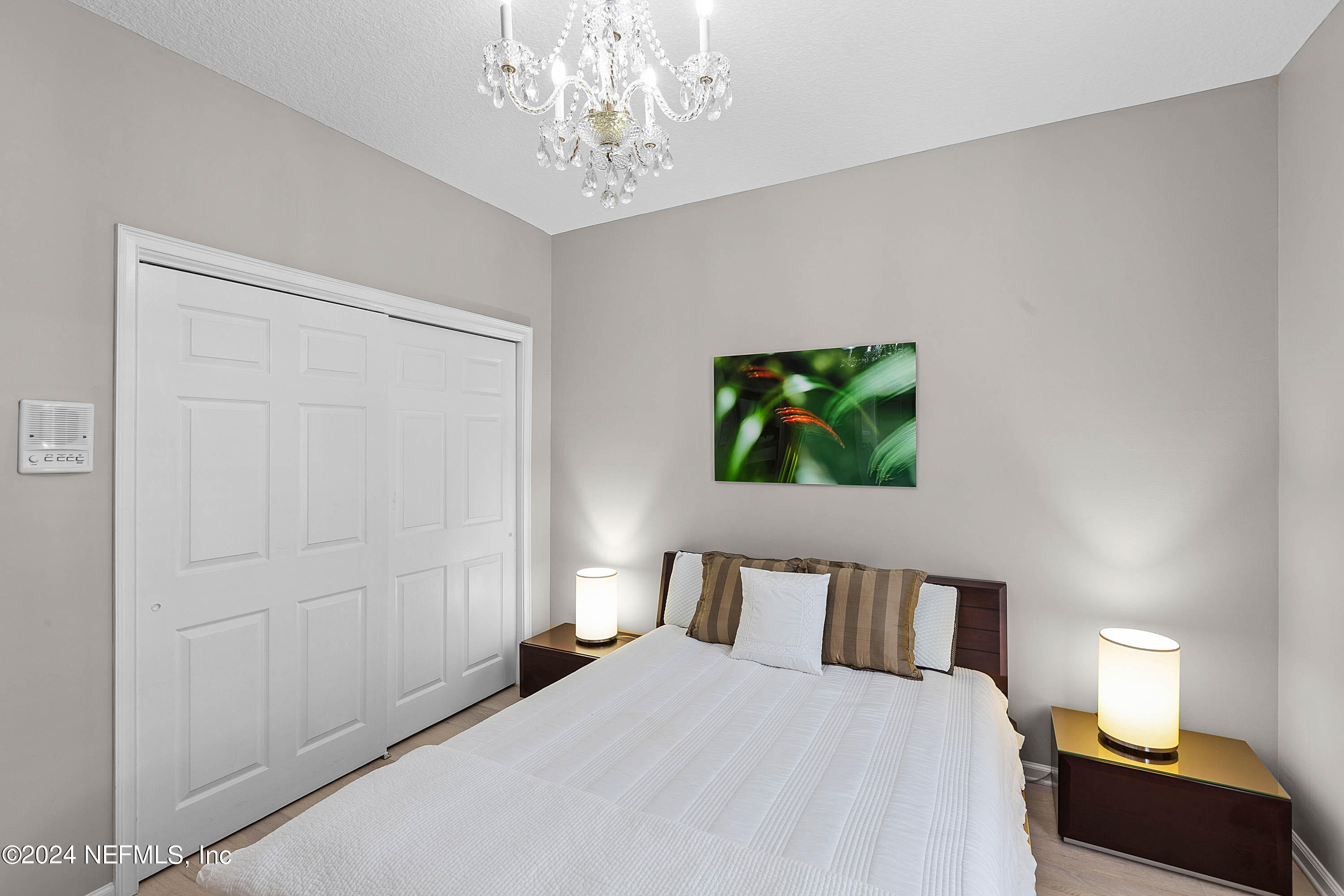 9975 Vineyard Lake Road East Jacksonville, FL 32256 - Photo 30 of 57 a bedroom with a bed and a chandelier