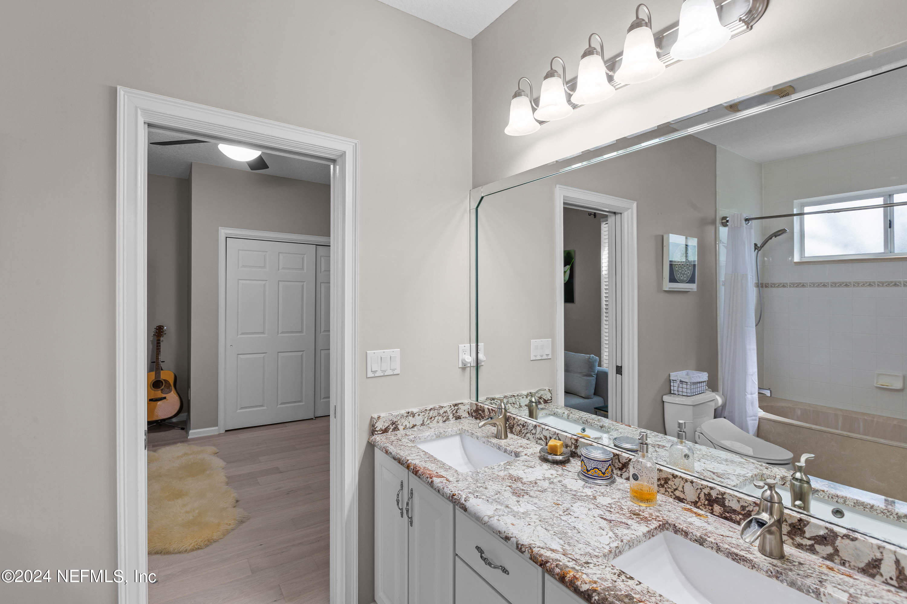 9975 Vineyard Lake Road East Jacksonville, FL 32256 - Photo 31 of 57 a bathroom with a granite countertop sink and a mirror