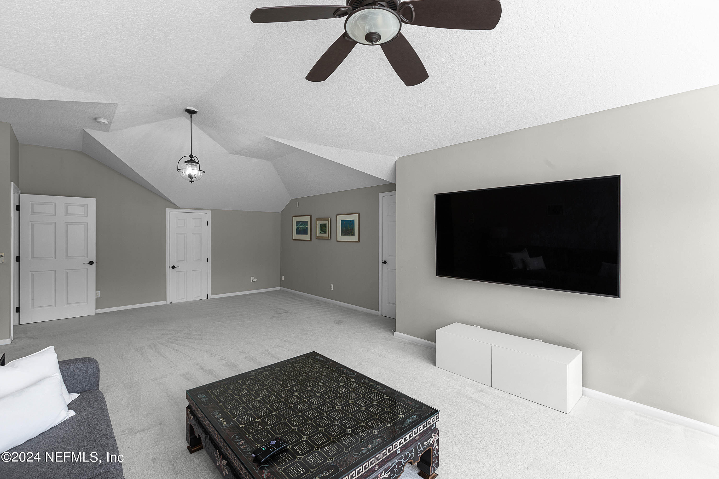 9975 Vineyard Lake Road East Jacksonville, FL 32256 - Photo 37 of 57 a living room with furniture and a flat screen tv