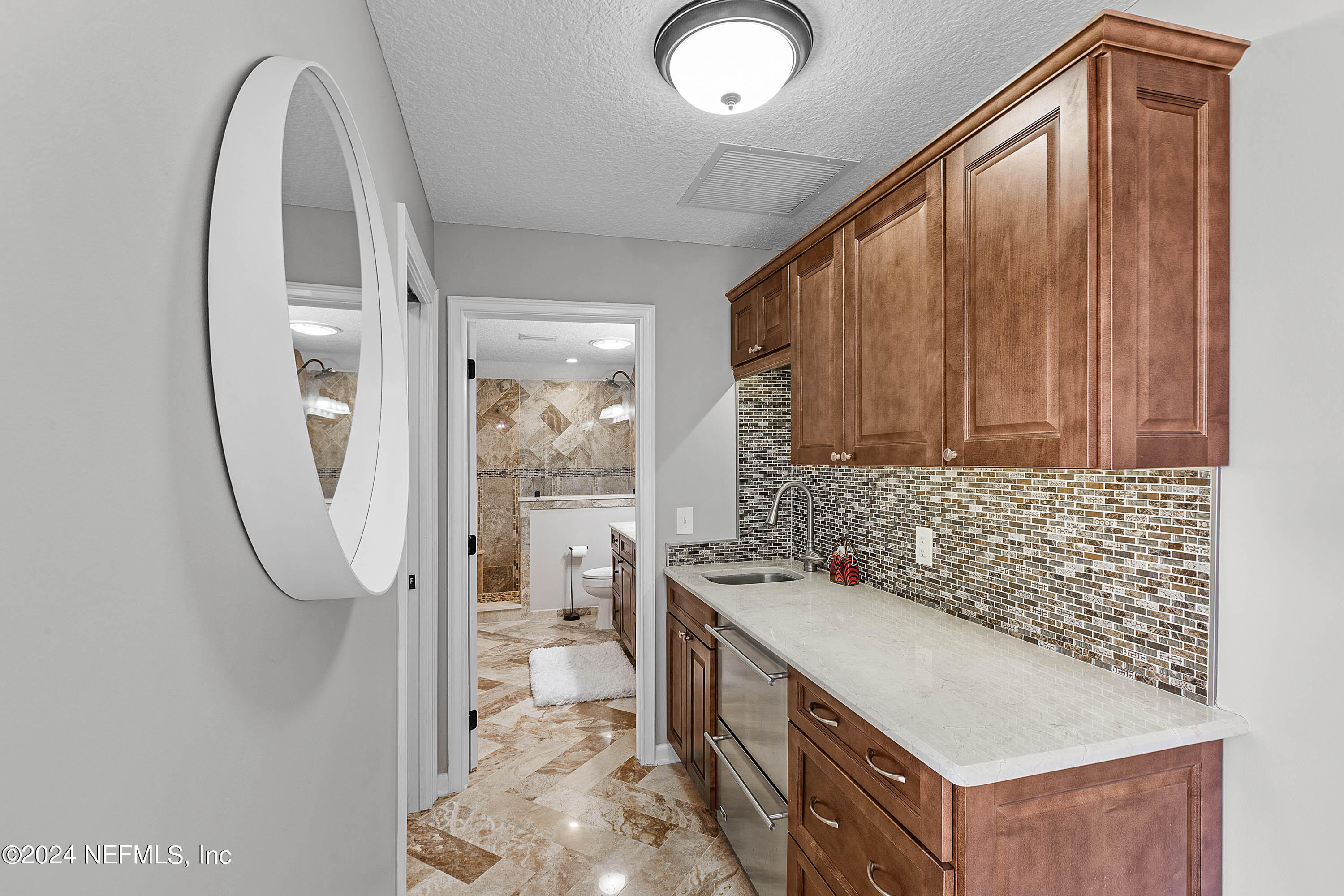 9975 Vineyard Lake Road East Jacksonville, FL 32256 - Photo 38 of 57 a bathroom with a granite countertop sink a mirror and a bathtub