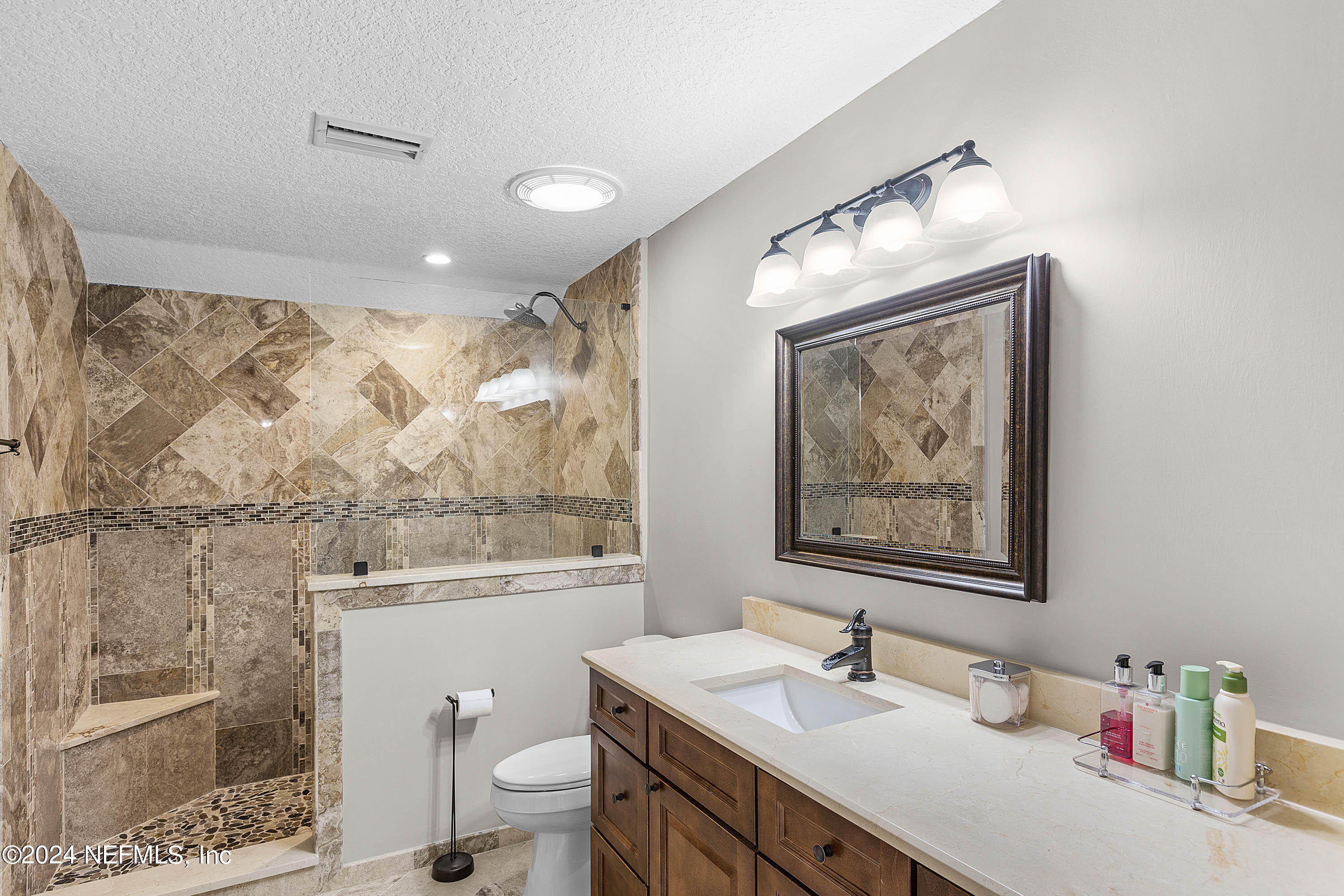 9975 Vineyard Lake Road East Jacksonville, FL 32256 - Photo 39 of 57 a bathroom with a sink vanity mirror and toilet
