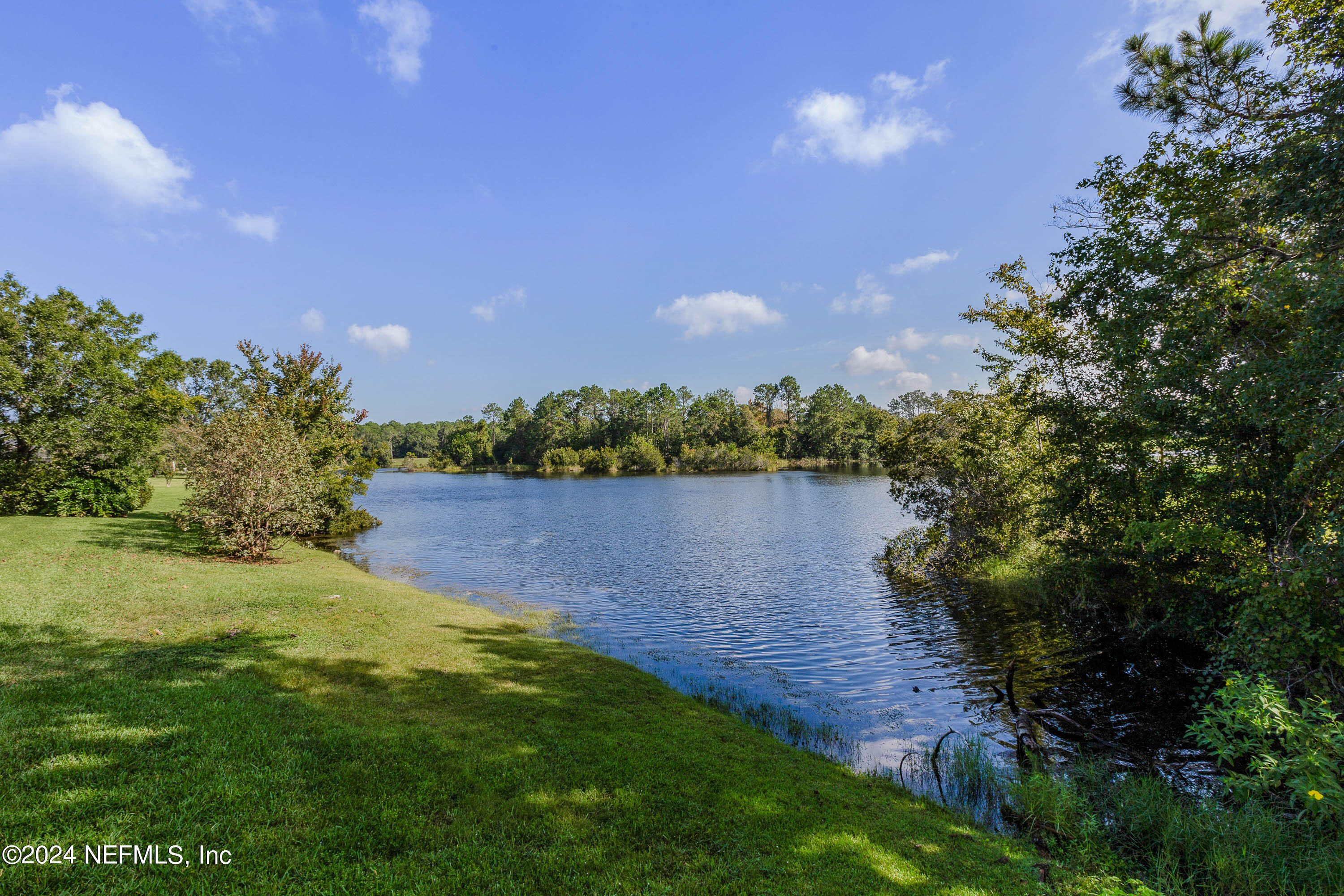 9975 Vineyard Lake Road East Jacksonville, FL 32256 - Photo 48 of 57 a view of a lake with houses in the back
