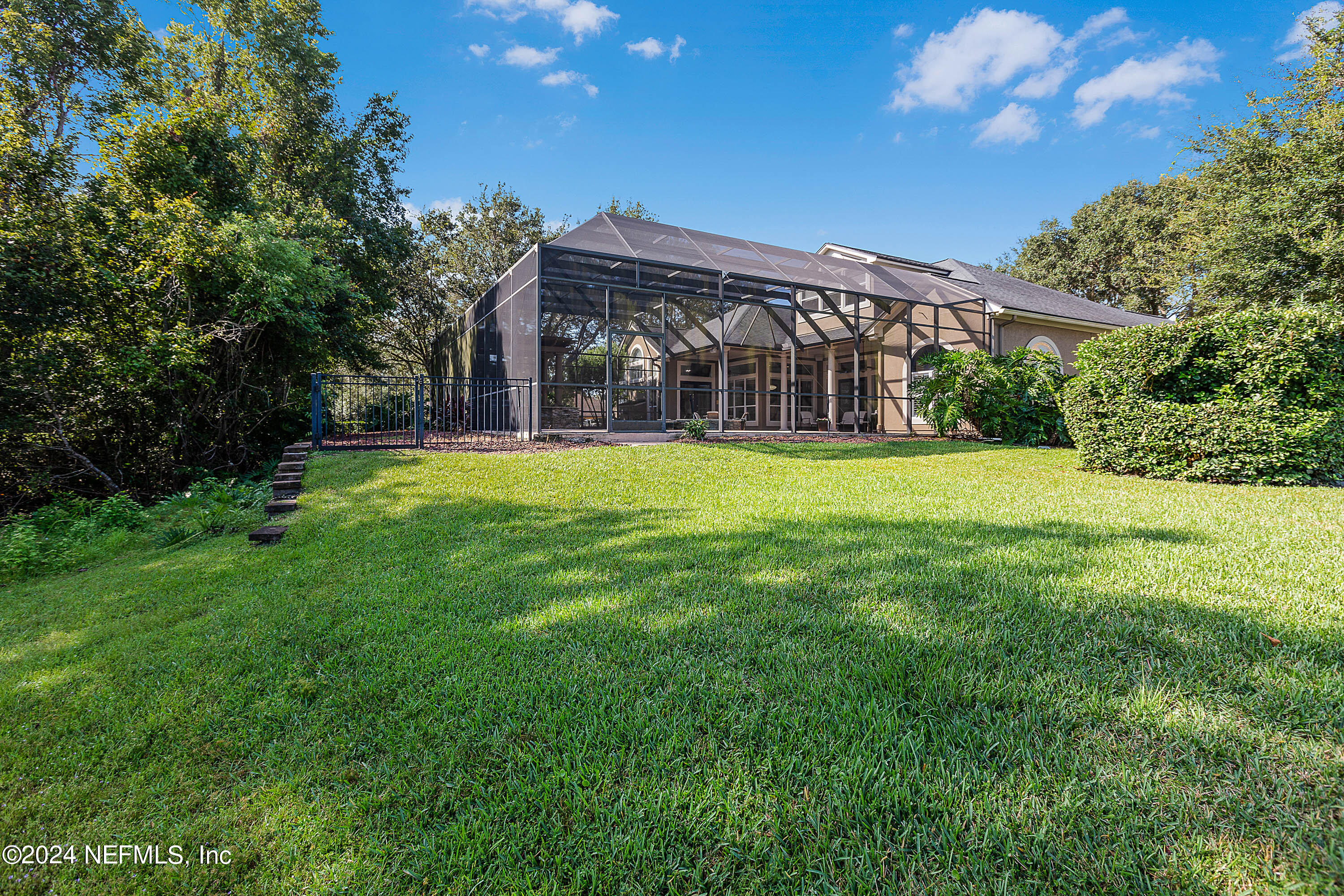 9975 Vineyard Lake Road East Jacksonville, FL 32256 - Photo 49 of 57 a view of a big house with a big yard and large trees