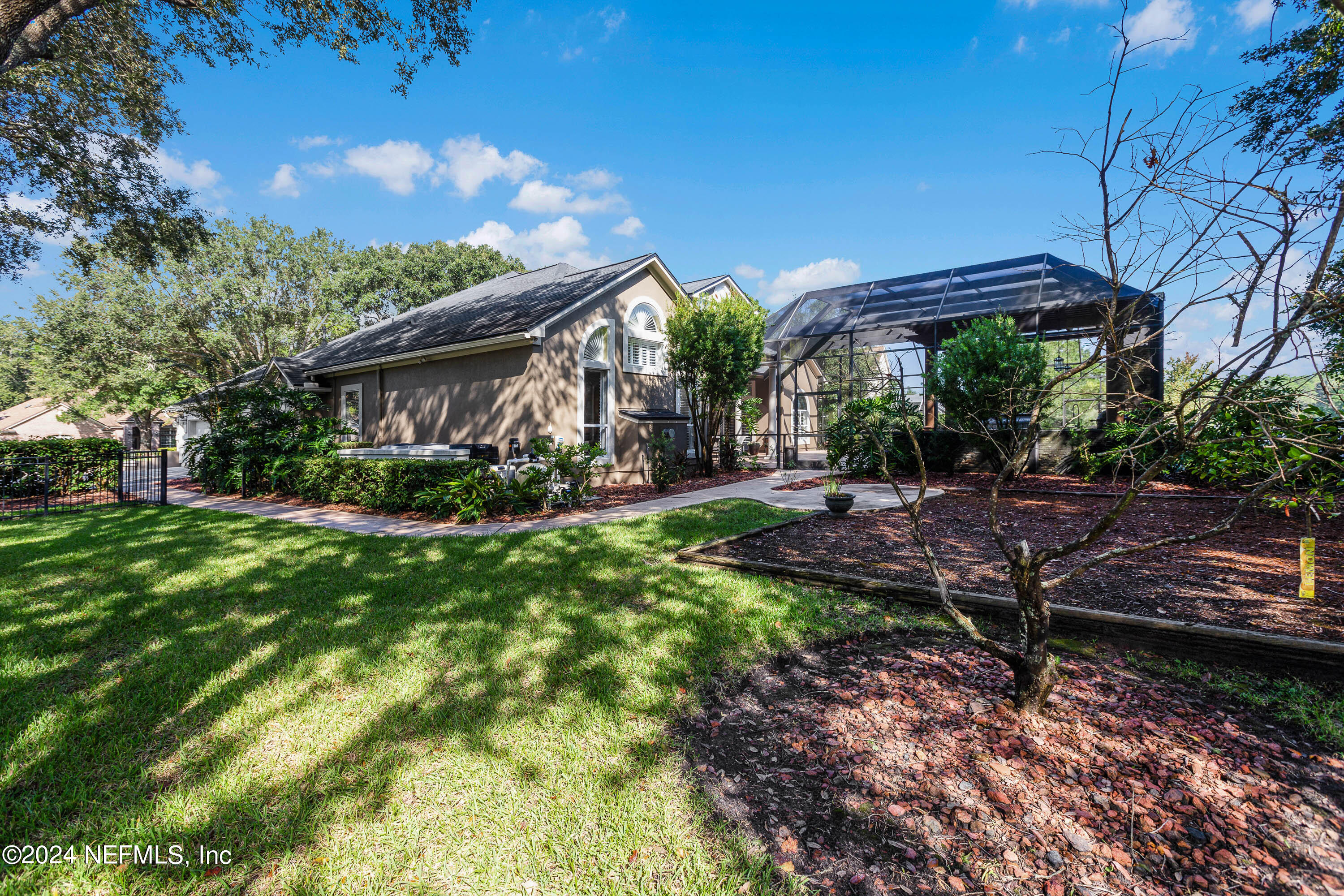 9975 Vineyard Lake Road East Jacksonville, FL 32256 - Photo 51 of 57 a view of a house with a backyard and a patio