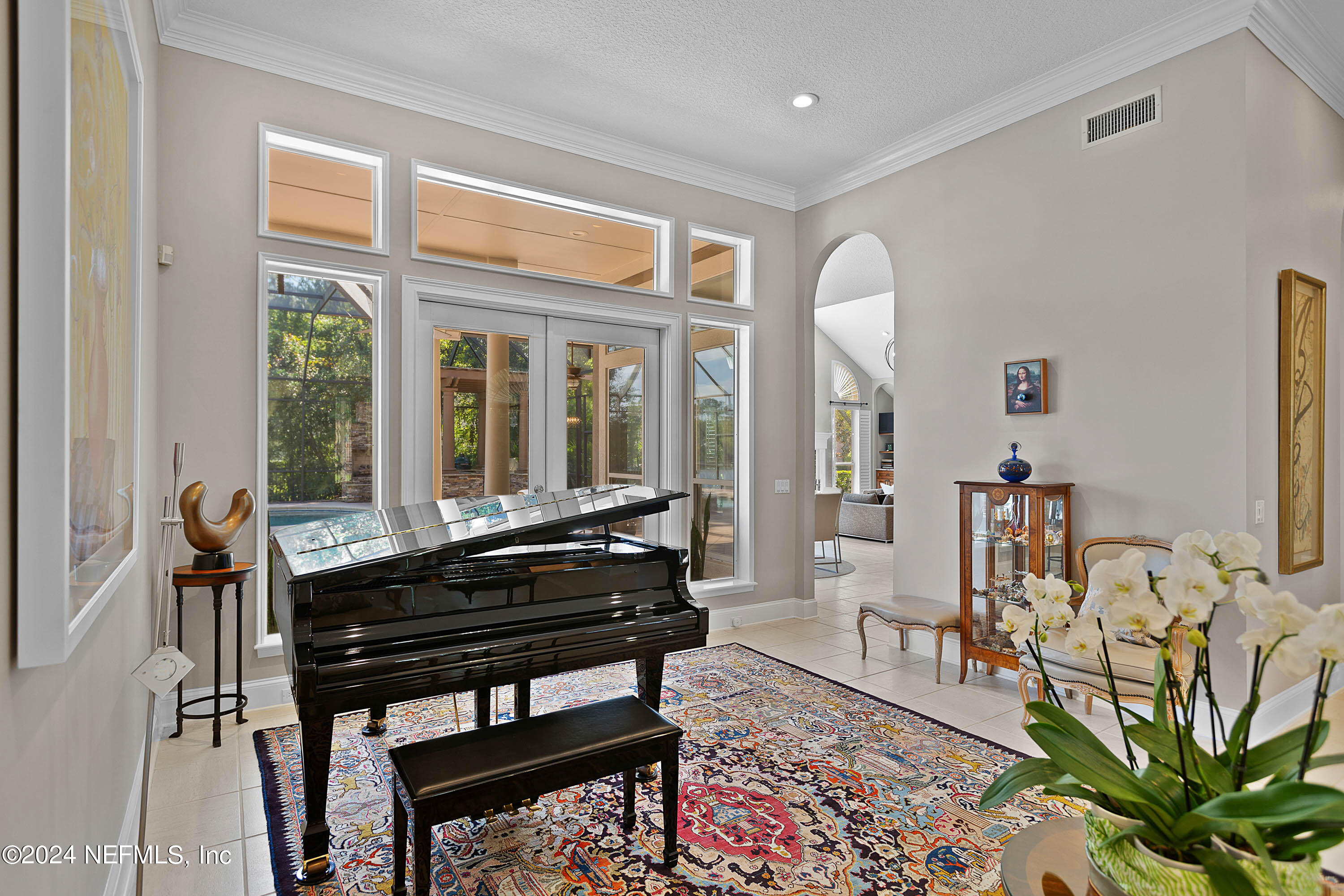 9975 Vineyard Lake Road East Jacksonville, FL 32256 - Photo 7 of 57 a living room with furniture a rug and a potted plant