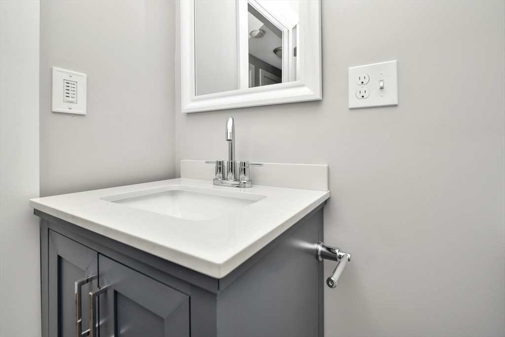 1903 Columbus Avenue Boston, MA 02119 - Photo 7 of 11 a bathroom with a sink and a mirror