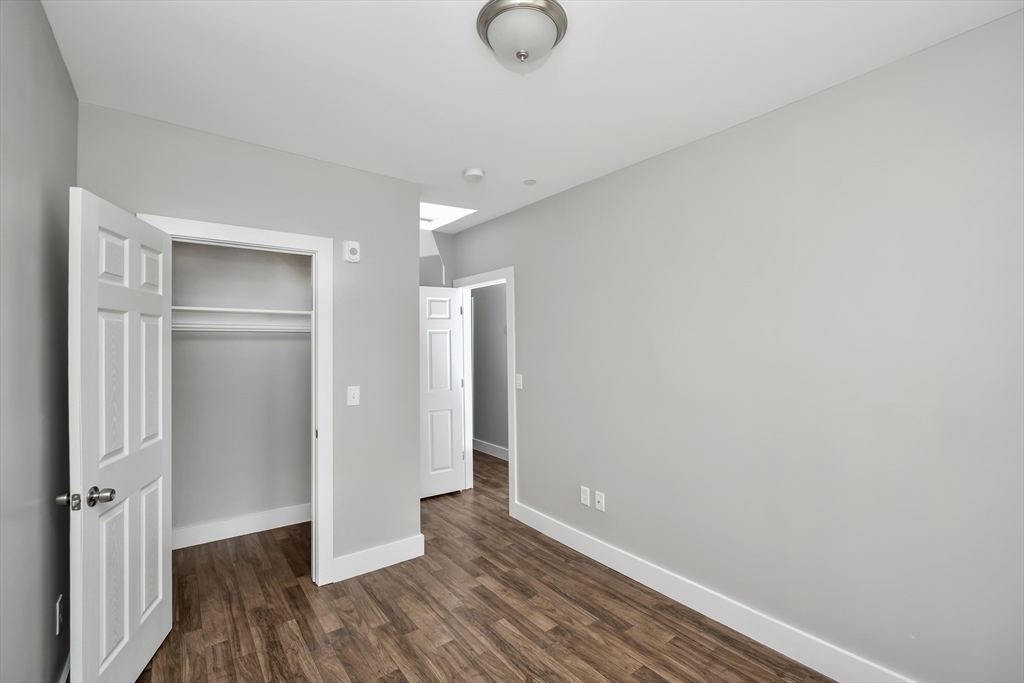 1903 Columbus Avenue Boston, MA 02119 - Photo 8 of 11 a view of room with wooden floor