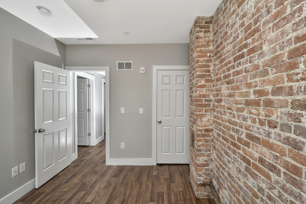 1903 Columbus Avenue Boston, MA 02119 - Photo 9 of 11 a view of a hallway with wooden floor and staircase