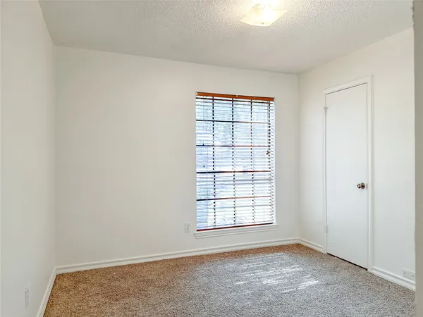 an empty room with a empty space and windows