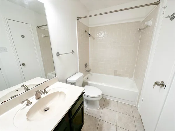 a bathroom with a sink mirror toilet and bathtub