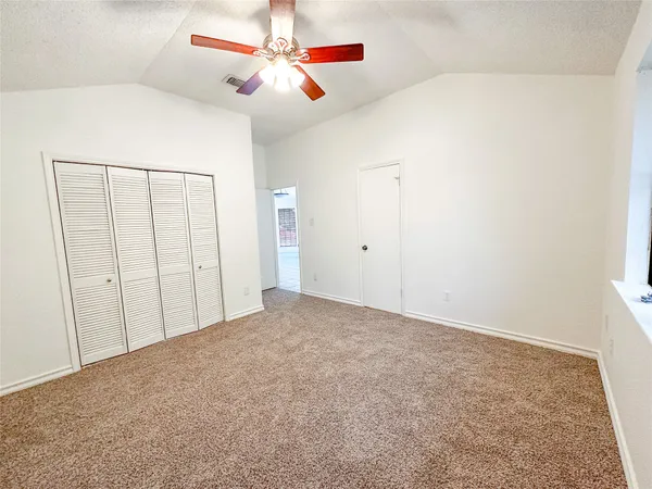 a view of a room with a ceiling fan