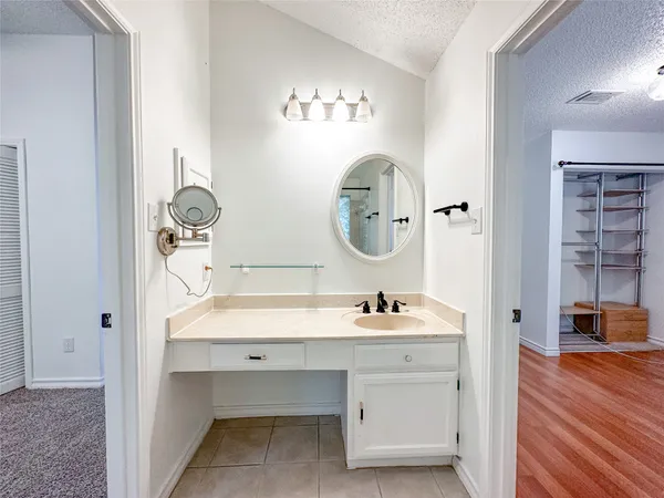 a bathroom with a sink vanity and mirror