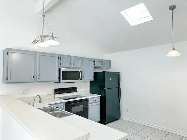 a kitchen with a refrigerator and a sink