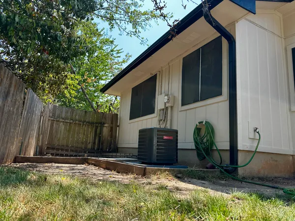 a view of a house with backyard and sitting area