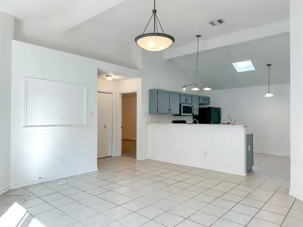 a view of a kitchen and a refrigerator