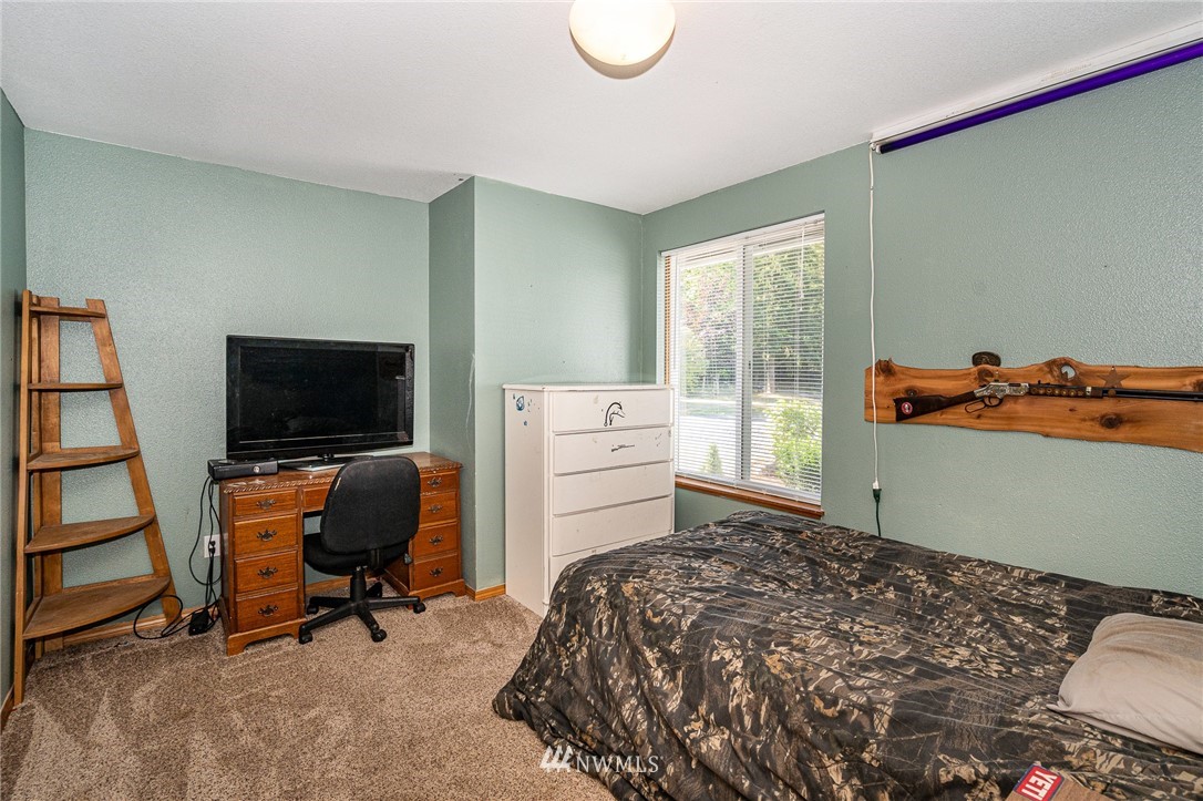 134 Mountain Sun Road Chehalis, WA 98532 - Photo 14 of 40 a bedroom with a bed and a flat screen tv