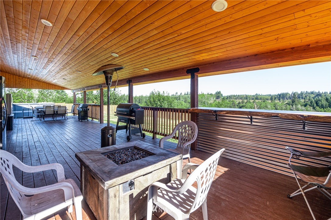 134 Mountain Sun Road Chehalis, WA 98532 - Photo 22 of 40 a view of a patio with a table chairs and wooden floor