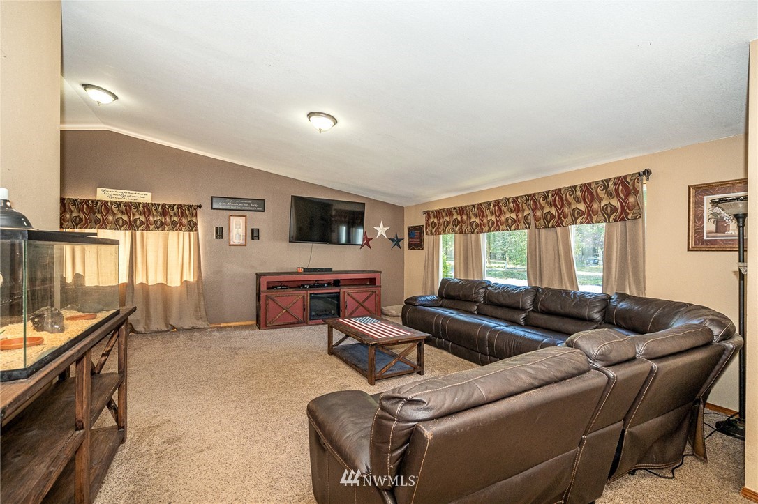 134 Mountain Sun Road Chehalis, WA 98532 - Photo 4 of 40 a living room with furniture and a flat screen tv