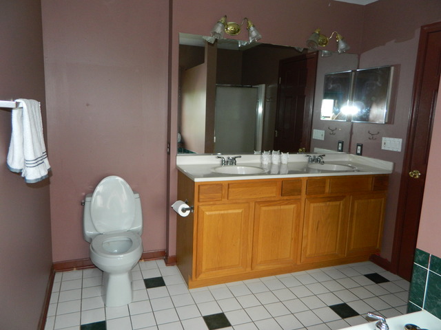 285 Rollin Road Somonauk, IL 60552 - Photo 14 of 25 a bathroom with a sink a toilet and mirror