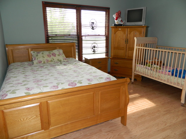 285 Rollin Road Somonauk, IL 60552 - Photo 15 of 25 a bedroom with a bed and wooden floor