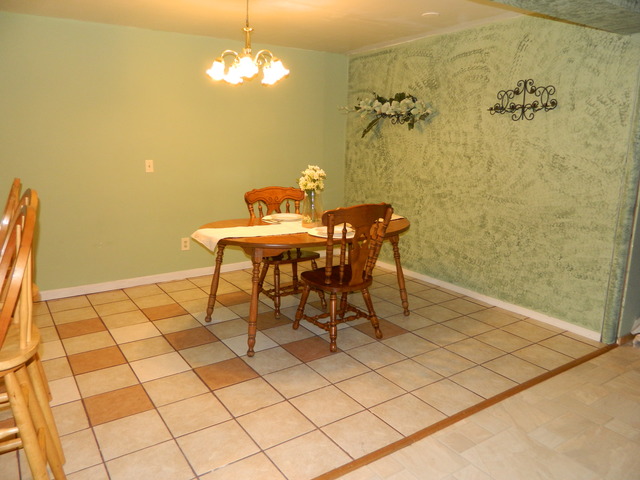 285 Rollin Road Somonauk, IL 60552 - Photo 22 of 25 a view of a dining room with furniture and a chandelier