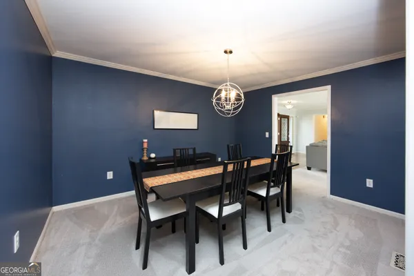 a living room with stainless steel appliances kitchen island granite countertop furniture and a wooden floor