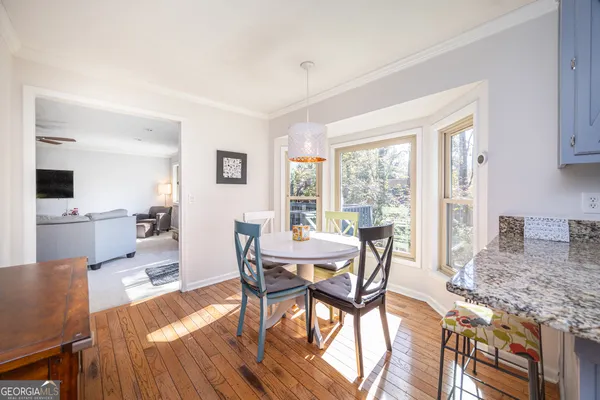 a dining room with furniture and window