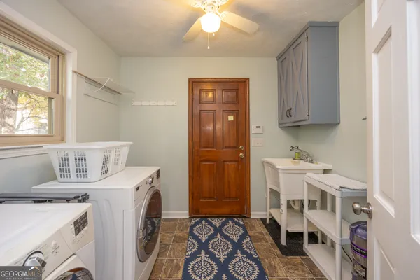 a bathroom with a tub sink and mirror