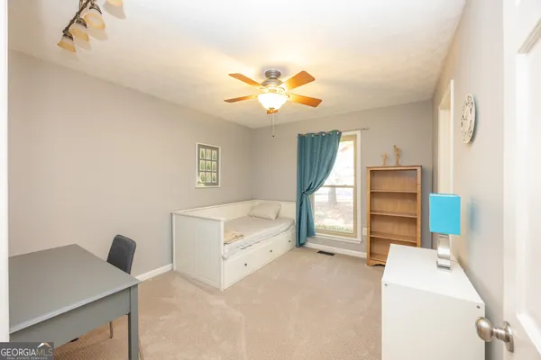 a bedroom with bed and window