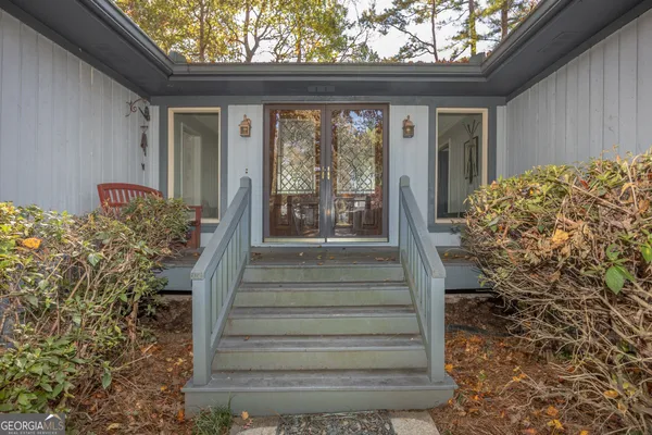 a view of a pathway of a house with plants and wooden floor