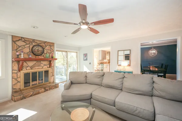 a living room with furniture a fireplace and a flat screen tv