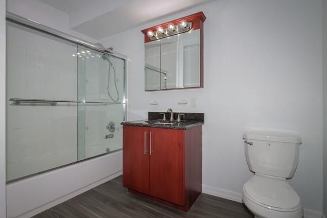 311 West Main Street, Unit 22 Patchogue, NY 11772 - Photo 9 of 9 a bathroom with a toilet a sink and mirror