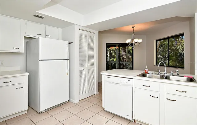 a utility room with cabinets washer and dryer