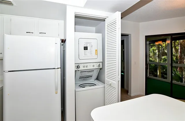 a white bathroom with a sink a toilet and a window