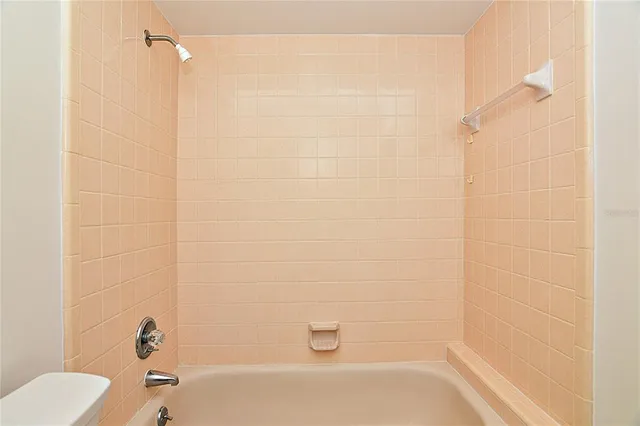 a bathroom with a shower and a toilet