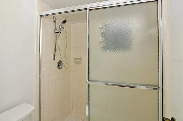 a bathroom that has a glass shower door