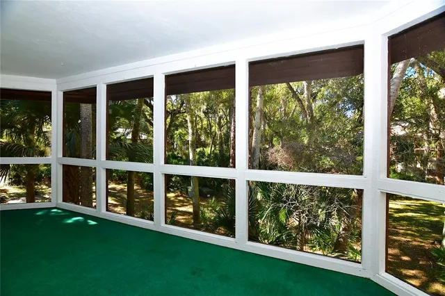 a view of an empty room with a large window and yard