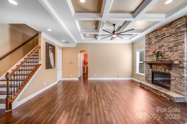 wooden floor in an empty room with a fireplace