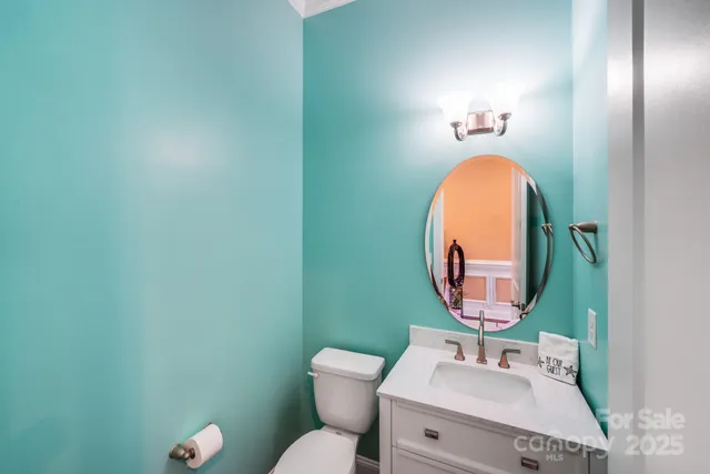 a bathroom with a toilet a sink and a mirror