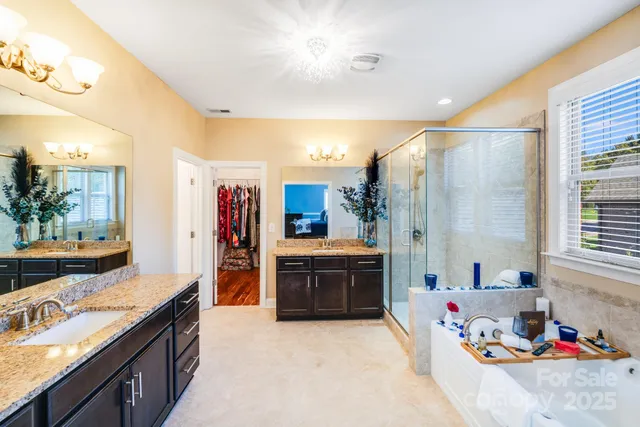 a bathroom with a tub sink and mirror