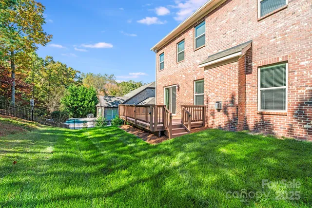 a view of a house with a yard and sitting area