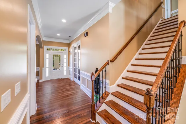 a view of entryway with wooden floor and stairs