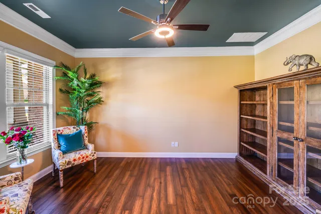 a living room with furniture and flowers