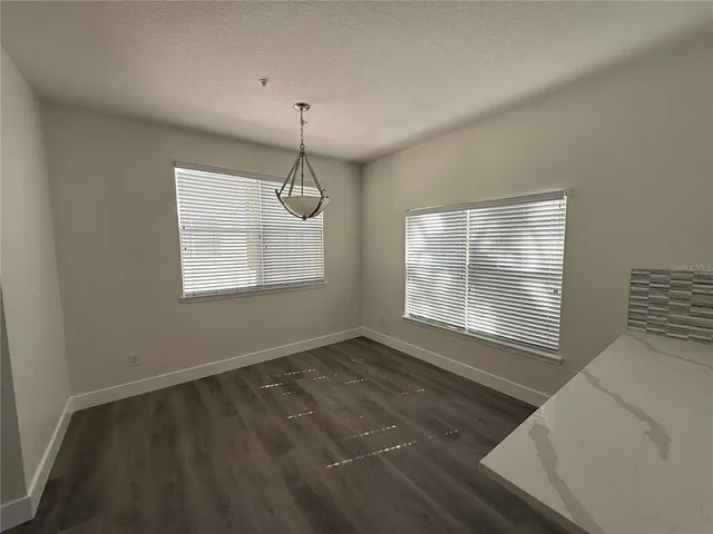 a view of an empty room with windows