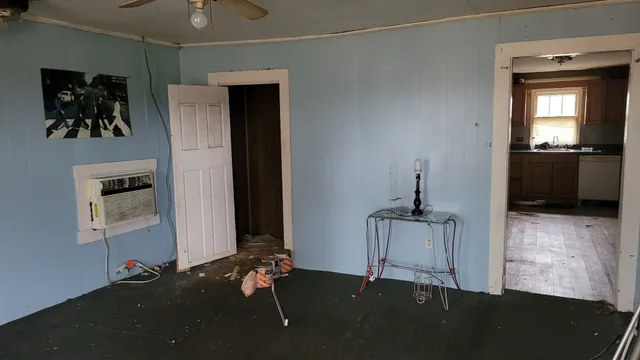 a room with gym equipment and a view of living room