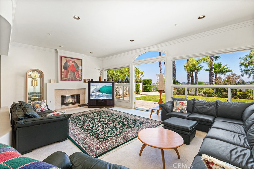 25191 Rockridge Road Laguna Hills, CA 92653 - Photo 11 of 33 a living room with furniture fireplace and window