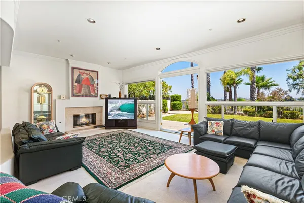 a living room with furniture fireplace and window