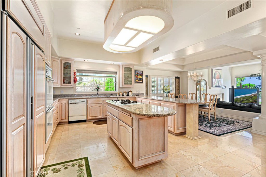 25191 Rockridge Road Laguna Hills, CA 92653 - Photo 13 of 33 a kitchen that has a lot of white cabinets and stainless steel appliances