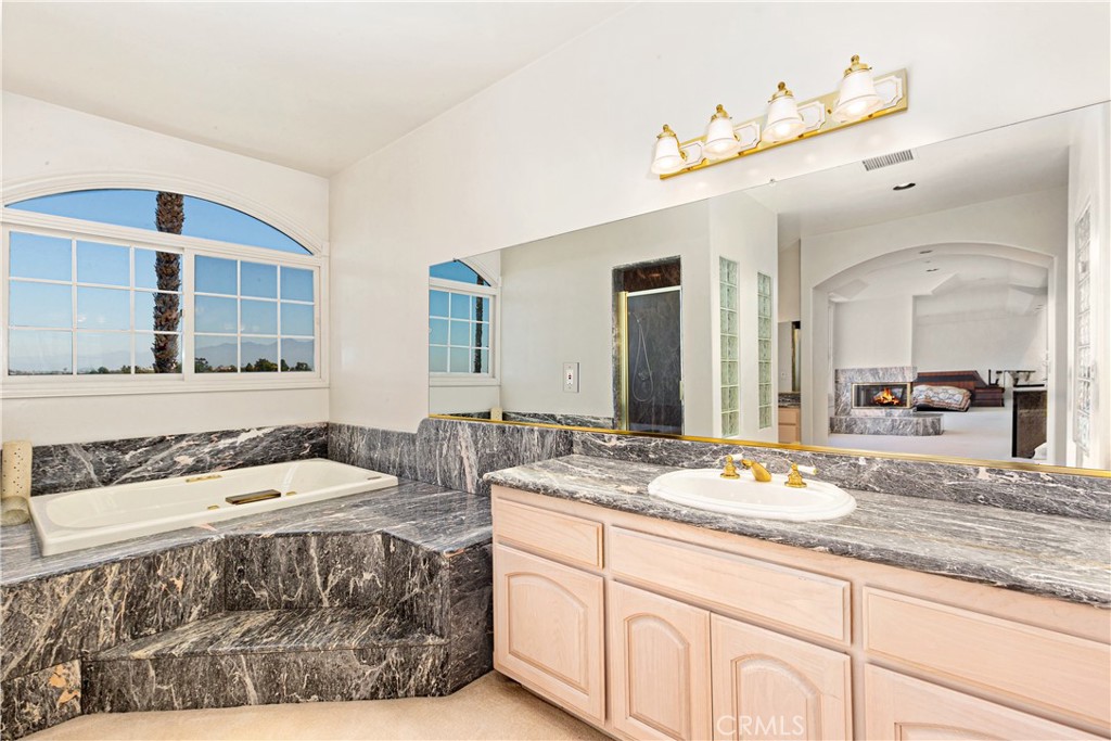 25191 Rockridge Road Laguna Hills, CA 92653 - Photo 19 of 33 a bathroom with a sink and a mirror